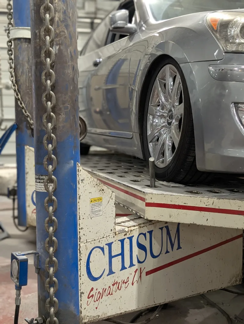 McCarthy Collision Center: A car being hosted up for repair