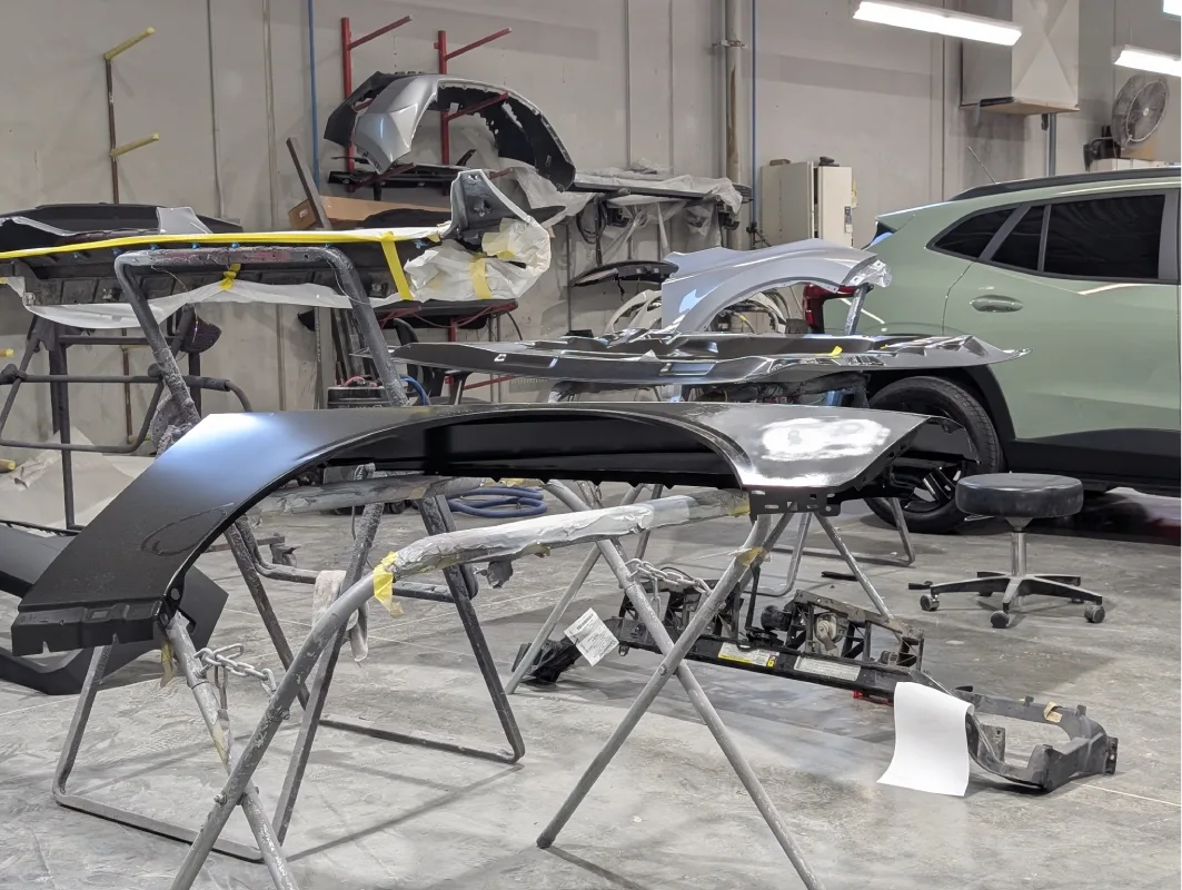 McCarthy Collision Center: A technician replacing the front bumper