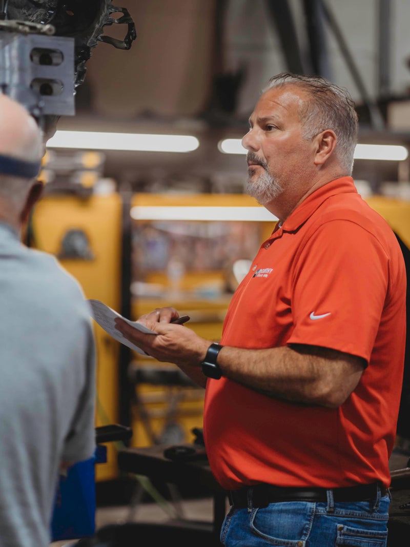 Service technicians inspecting a car - McCarthy Collision Center in Olathe KS