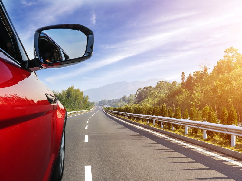 McCarthy Collision Center in Olathe KS newly repaired car driving on highway