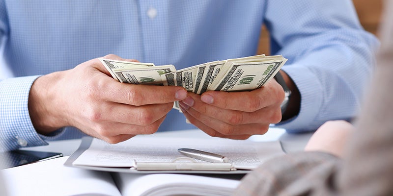 McCarthy Collision Center in Olathe KS customer holding cash