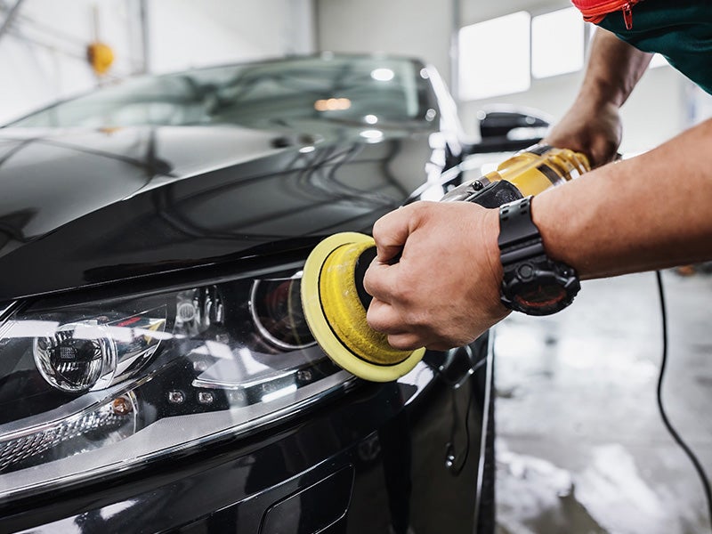 McCarthy Collision Center in Olathe KS technician buffing car